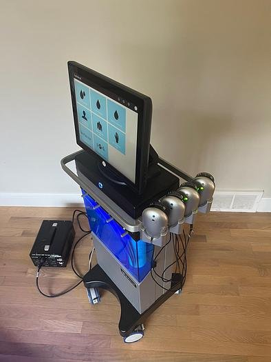 Hydrafacial handpiece performing deep cleansing facial treatment